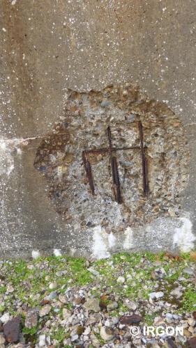 View showing spalling (damage to concrete wall) following impact